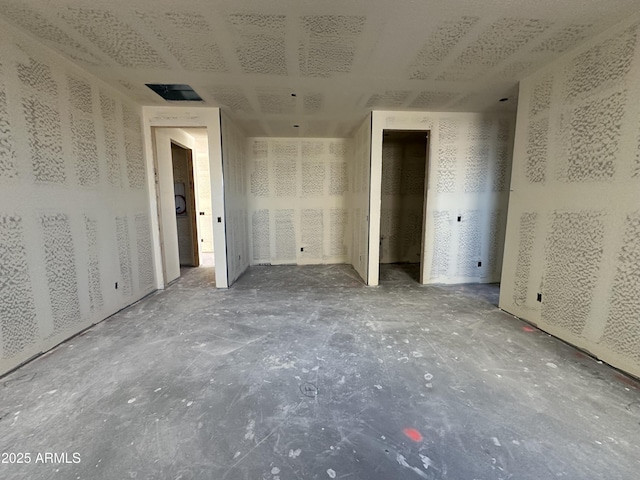 unfurnished bedroom featuring visible vents