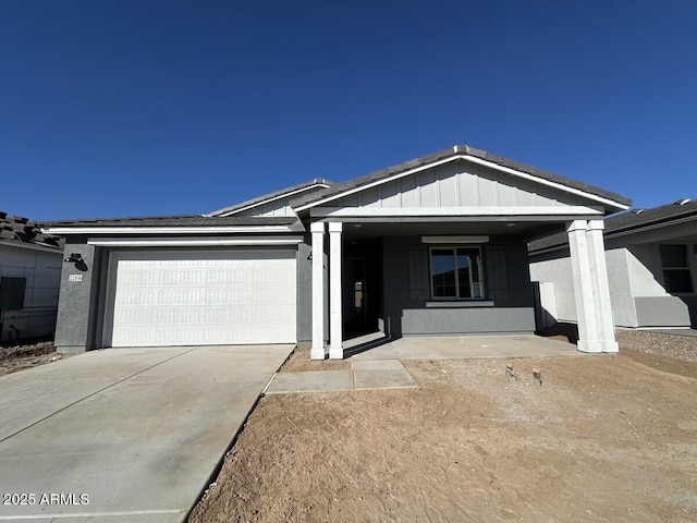 single story home with a garage, driveway, and stucco siding