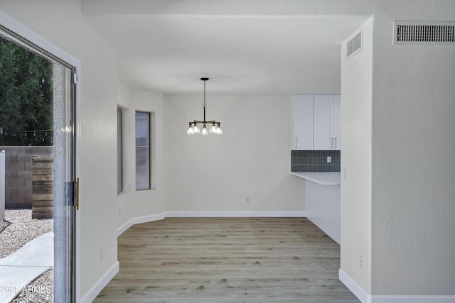 1003 E Princeton Ave, Gilbert, AZ 85234 - unfurnished dining area featuring a chandelier and light wood-type flooring