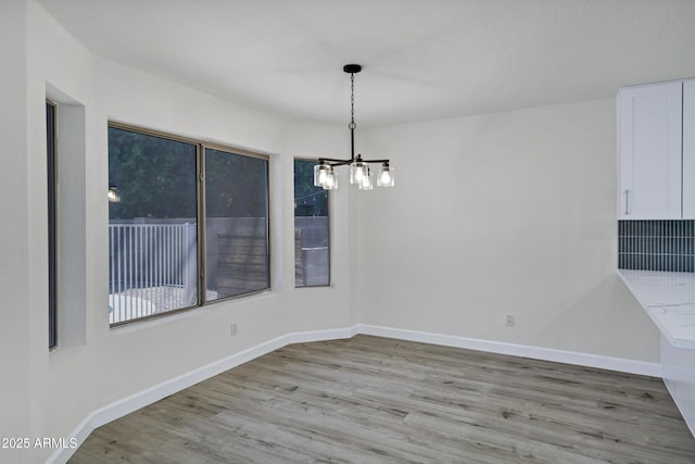 1003 E Princeton Ave, Gilbert, AZ 85234 - unfurnished dining area with a chandelier and light wood-style flooring