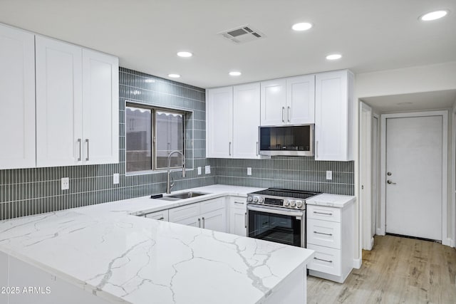 1003 E Princeton Ave, Gilbert, AZ 85234 - kitchen with appliances with stainless steel finishes, light stone counters, white cabinets, recessed lighting, and tasteful backsplash