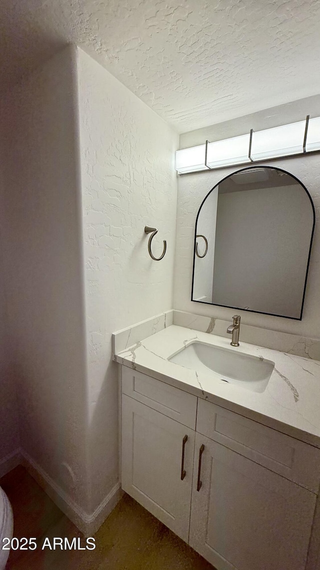 1003 E Princeton Ave, Gilbert, AZ 85234 - bathroom featuring a textured ceiling, vanity, and a textured wall