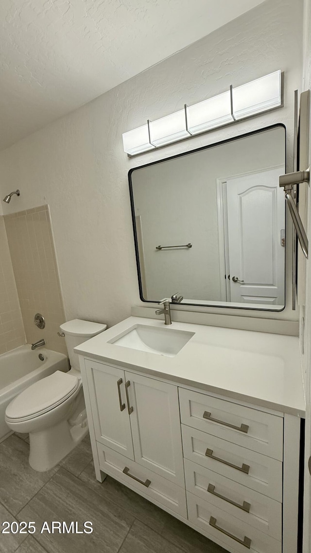 1003 E Princeton Ave, Gilbert, AZ 85234 - bathroom with vanity, shower / bath combination, a textured wall, a textured ceiling, and wood finished floors