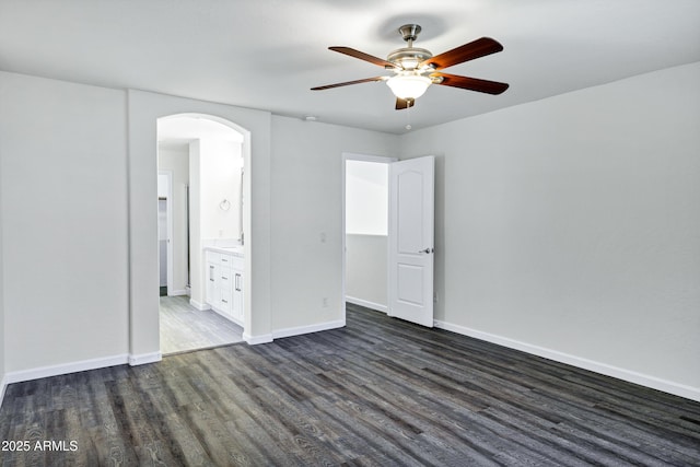 1003 E Princeton Ave, Gilbert, AZ 85234 - unfurnished room featuring arched walkways, dark wood-style flooring, and ceiling fan