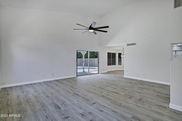 1003 E Princeton Ave, Gilbert, AZ 85234 - unfurnished living room featuring a ceiling fan, wood finished floors, and a towering ceiling