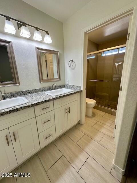 10101 N 91st Ave Unit 88, Peoria, AZ 85345 - bathroom featuring double vanity and a shower stall