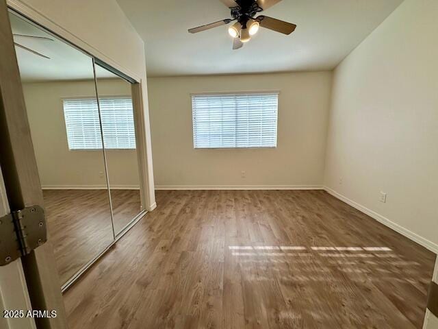 10101 N 91st Ave Unit 88, Peoria, AZ 85345 - unfurnished bedroom with wood finished floors, a closet, and ceiling fan