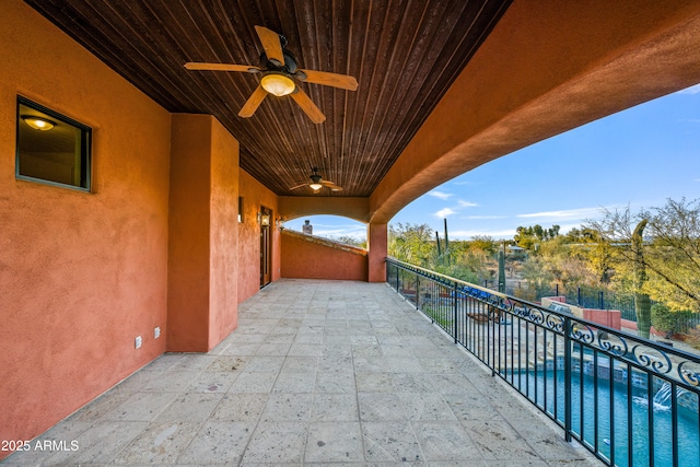 view of patio featuring a fenced in pool, a balcony, and ceiling fan