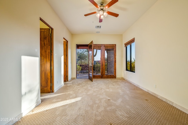 interior space featuring light carpet and ceiling fan