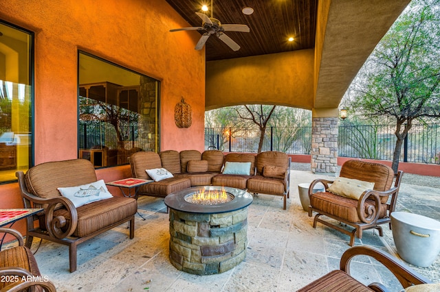 view of patio / terrace with an outdoor living space with a fire pit and ceiling fan