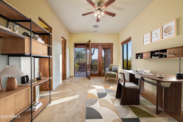 carpeted home office featuring ceiling fan