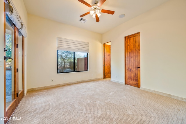 unfurnished bedroom with light colored carpet and ceiling fan