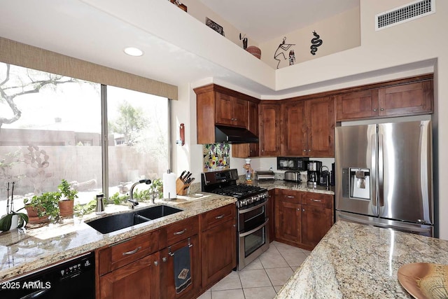 6966 E Bramble Berry Ln, Scottsdale, AZ 85266 - kitchen featuring appliances with stainless steel finishes, a sink, light stone counters, light tile patterned floors, and under cabinet range hood