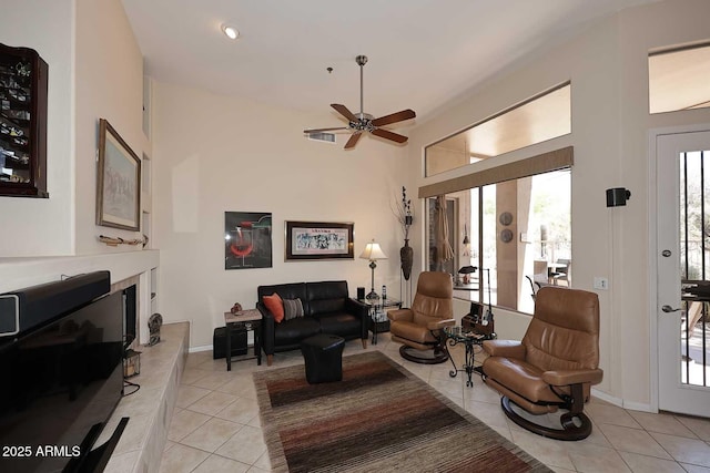 6966 E Bramble Berry Ln, Scottsdale, AZ 85266 - living area with light tile patterned floors, a ceiling fan, and a high end fireplace