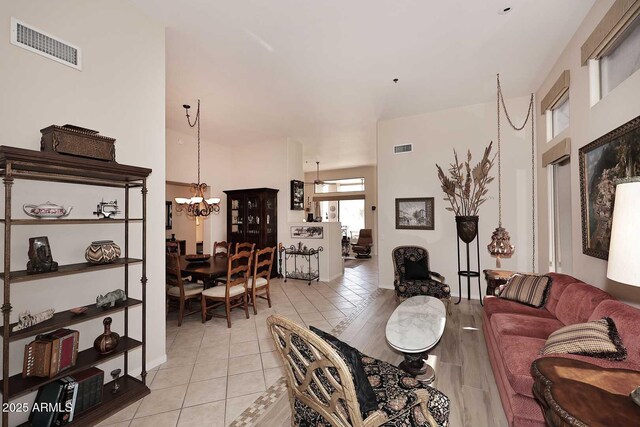 6966 E Bramble Berry Ln, Scottsdale, AZ 85266 - living room with a chandelier, baseboards, and light tile patterned floors