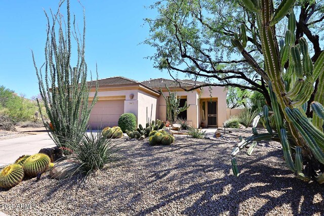 6966 E Bramble Berry Ln, Scottsdale, AZ 85266 - view of front of property featuring stucco siding and an attached garage