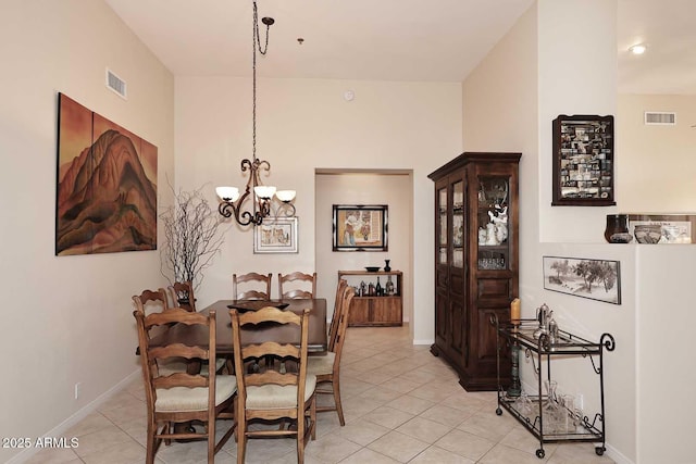 6966 E Bramble Berry Ln, Scottsdale, AZ 85266 - dining room featuring light tile patterned floors, a chandelier, and baseboards