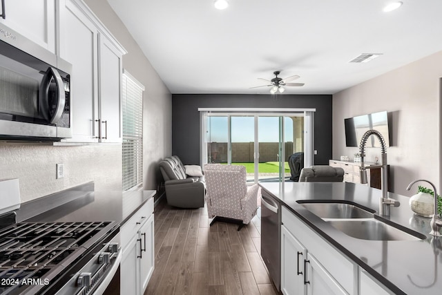 kitchen with white cabinetry, sink, dark wood-type flooring, and appliances with stainless steel finishes