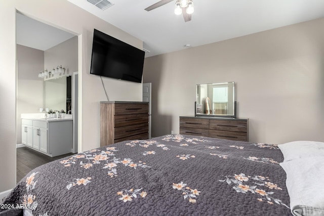 bedroom featuring ceiling fan, dark hardwood / wood-style floors, and ensuite bathroom