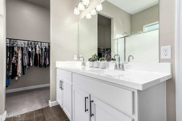 bathroom featuring vanity, hardwood / wood-style flooring, and a shower with door