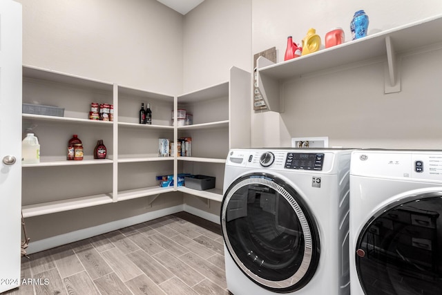 clothes washing area with light hardwood / wood-style floors and independent washer and dryer