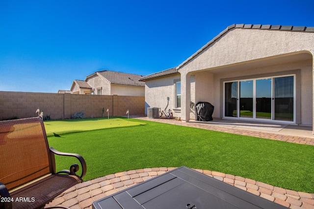 view of yard with a patio area and central air condition unit