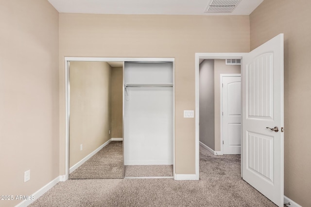 1367 S Country Club Dr Unit 1327, Mesa, AZ 85210 - unfurnished bedroom featuring carpet, a closet, and baseboards
