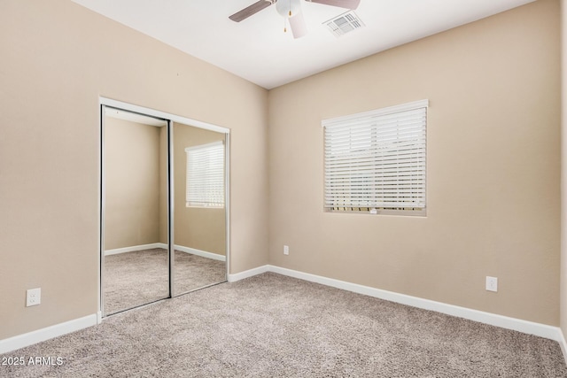 1367 S Country Club Dr Unit 1327, Mesa, AZ 85210 - unfurnished bedroom featuring carpet flooring, a closet, baseboards, and a ceiling fan