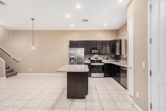1367 S Country Club Dr Unit 1327, Mesa, AZ 85210 - kitchen with stainless steel appliances, decorative backsplash, a center island, light tile patterned floors, and light stone countertops