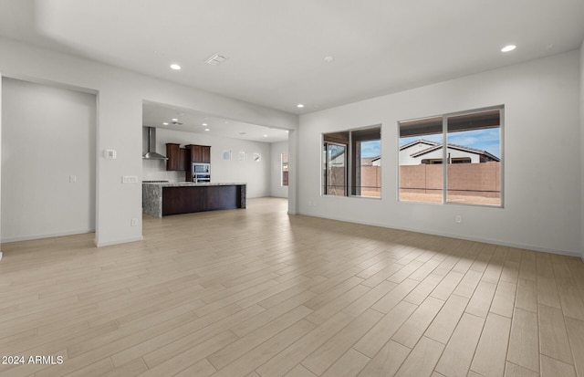 unfurnished living room with light hardwood / wood-style flooring