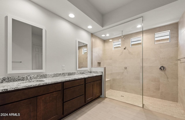 bathroom with vanity and tiled shower