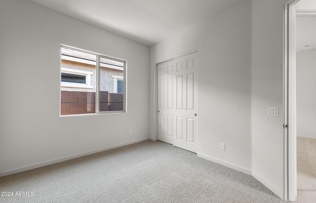 unfurnished room featuring light carpet