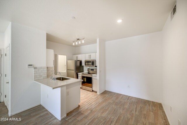 unfurnished room with ceiling fan and light hardwood / wood-style flooring