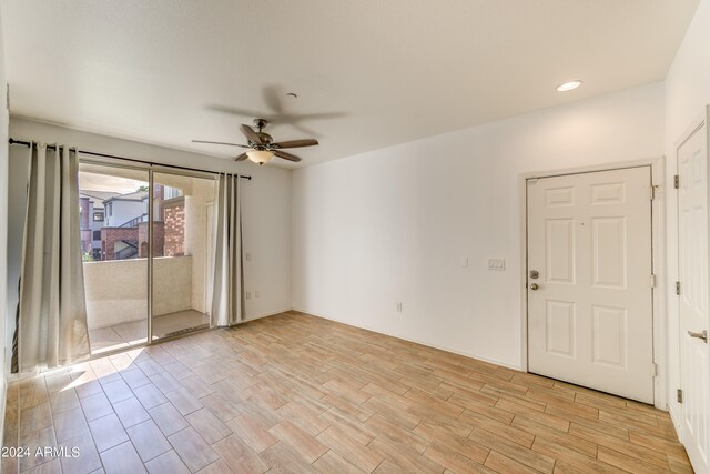 spare room with ceiling fan and light hardwood / wood-style flooring