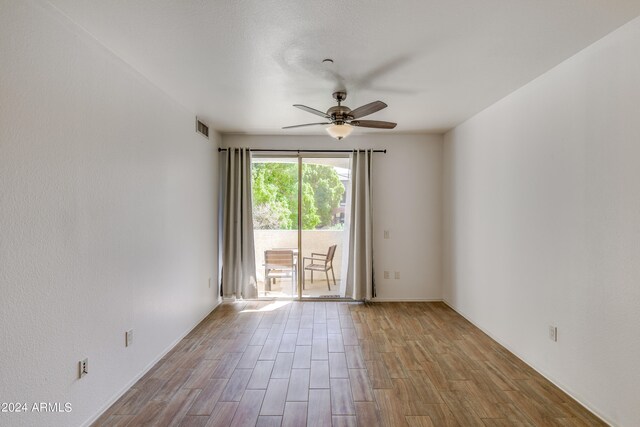 spare room featuring light wood-type flooring and ceiling fan