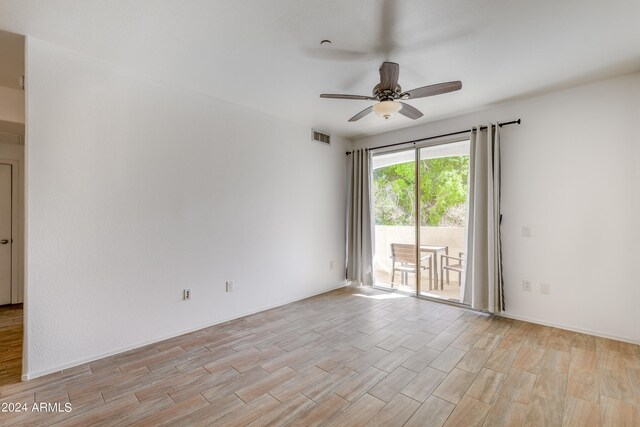 unfurnished room featuring light wood-type flooring and ceiling fan