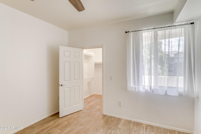 empty room featuring ceiling fan and light wood-type flooring