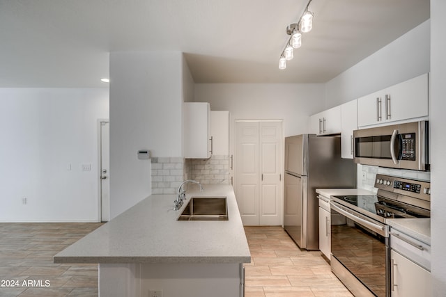 kitchen featuring stainless steel appliances, light wood-type flooring, sink, and white cabinetry