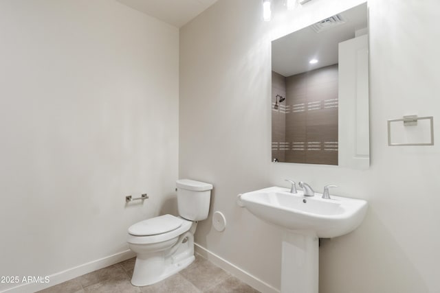 bathroom featuring tile patterned flooring, toilet, and sink