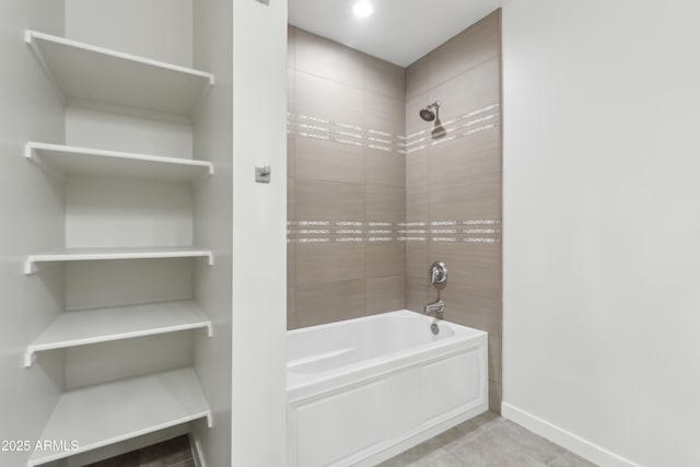 bathroom featuring tile patterned floors and tiled shower / bath