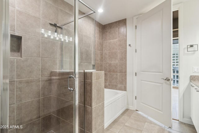 bathroom with plus walk in shower, vanity, and tile patterned floors