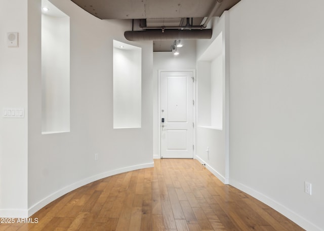 corridor featuring wood-type flooring