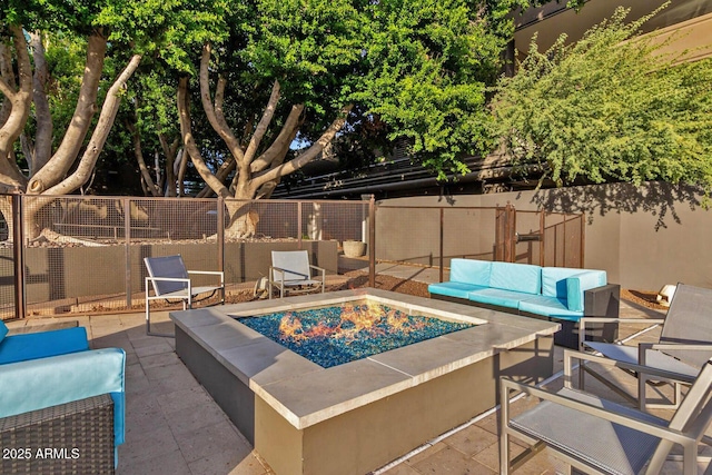 view of swimming pool featuring a patio and an outdoor living space with a fire pit