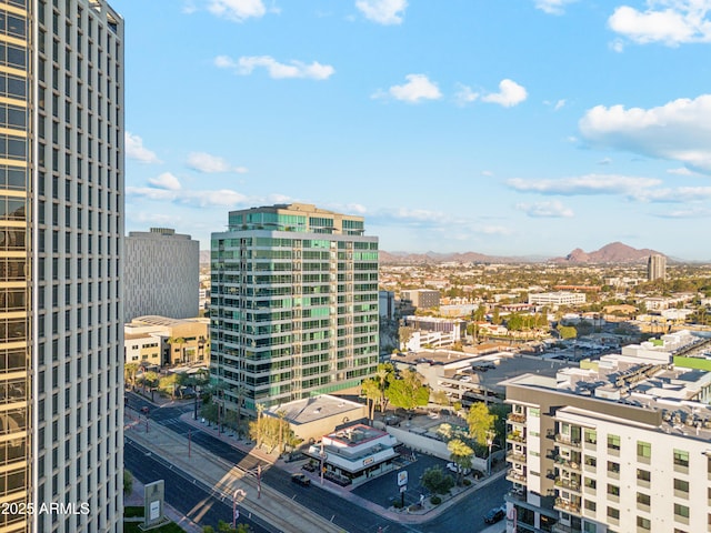 property's view of city with a mountain view