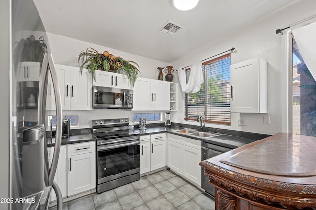 11383 W Pima St, Avondale, AZ 85323 - kitchen featuring stainless steel appliances, dark countertops, and white cabinetry