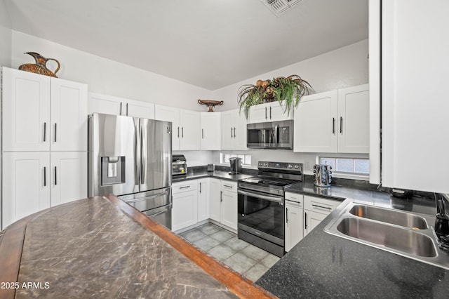 11383 W Pima St, Avondale, AZ 85323 - kitchen with appliances with stainless steel finishes, white cabinets, and dark countertops
