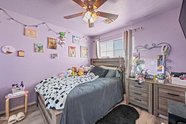 11383 W Pima St, Avondale, AZ 85323 - bedroom with light wood-style flooring, a textured ceiling, and ceiling fan