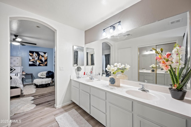 11383 W Pima St, Avondale, AZ 85323 - bathroom with double vanity, wood finished floors, connected bathroom, and a ceiling fan