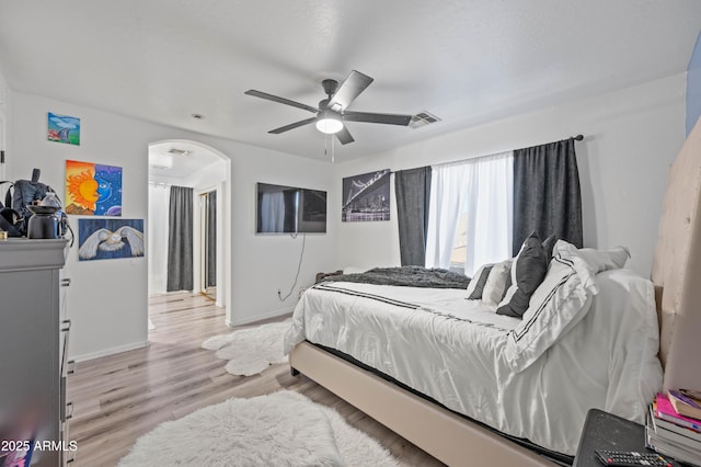 11383 W Pima St, Avondale, AZ 85323 - bedroom featuring wood finished floors, arched walkways, and ceiling fan