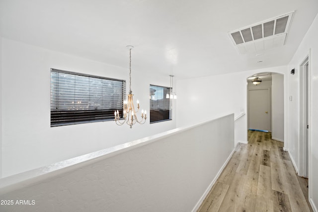 11383 W Pima St, Avondale, AZ 85323 - corridor with a chandelier, arched walkways, and wood finished floors